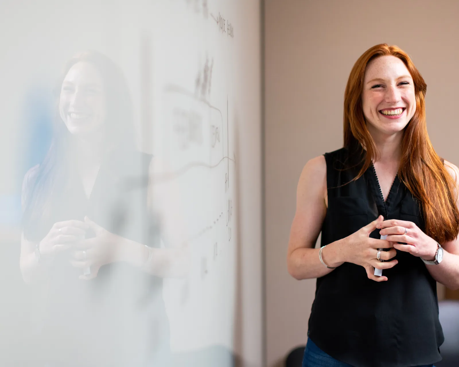 A female leader in the boardroom leading with calm and confidence.